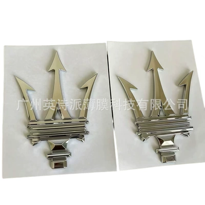 Car logo English Logo Ghibli - a-pair-of-three-pronged-marks-bright-silver