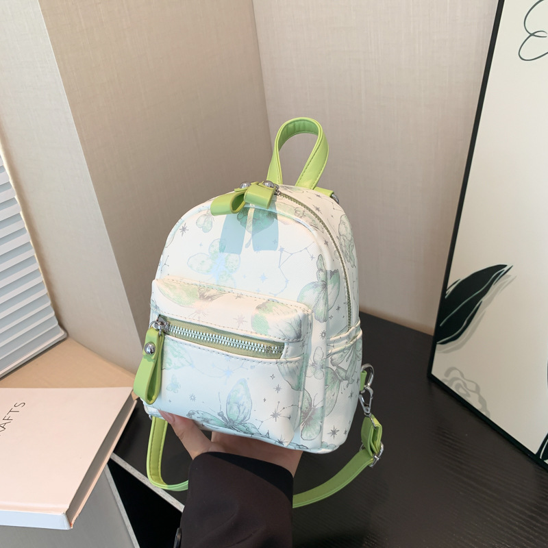 Mochila japonesa fresca para damas dulce flor impresión de aire extranjero mochila pequeña 2025 nuevo mini bolso