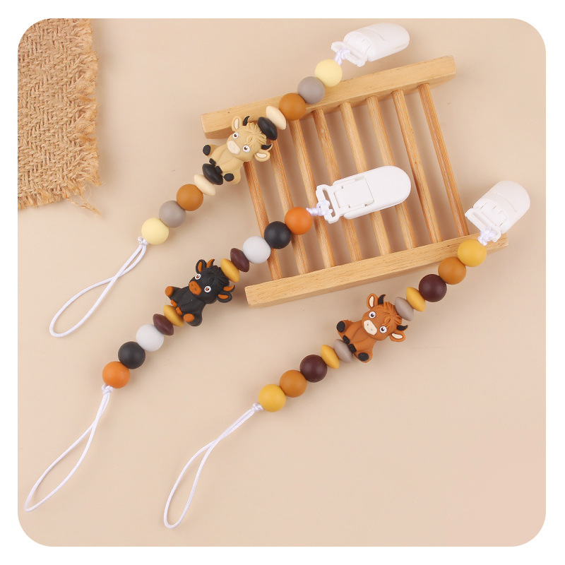Productos infantiles de dibujos animados tridimensionales de vaca anti-caída cadena creativa bebé DIY silicona mordedor de goma molar calmar la cadena de tetina