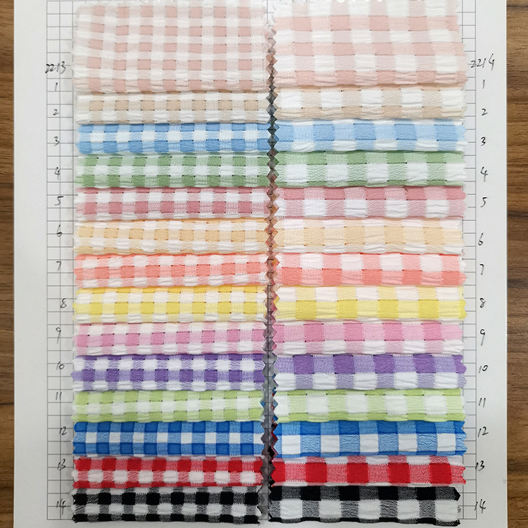 2022新款糖果色镂空格子布泡泡纱色织面料童装连衣裙上衣服装布料