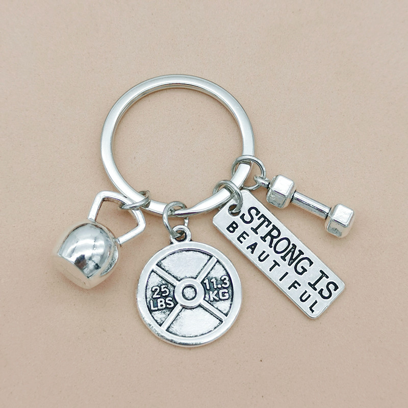 Nueva joyería europea y americana deportes poder mancuerna barra hervidor campana llavero hombres y mujeres pareja amistad llavero