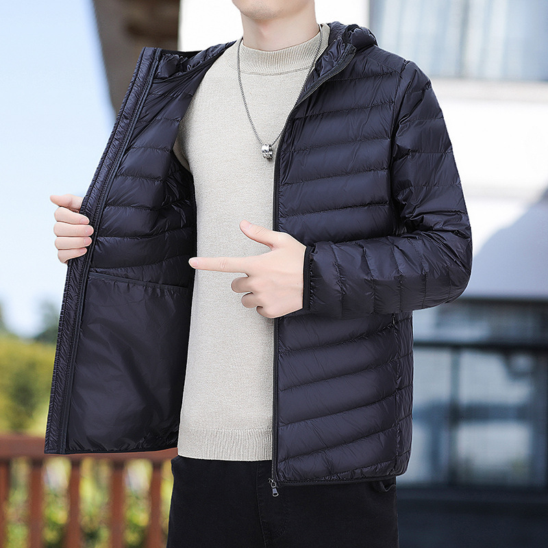 2023 Otoño e Invierno ligero abajo abrigo de algodón acolchado con capucha de los hombres regular más el tamaño abrigo de moda entrega de una sola pieza de los hombres