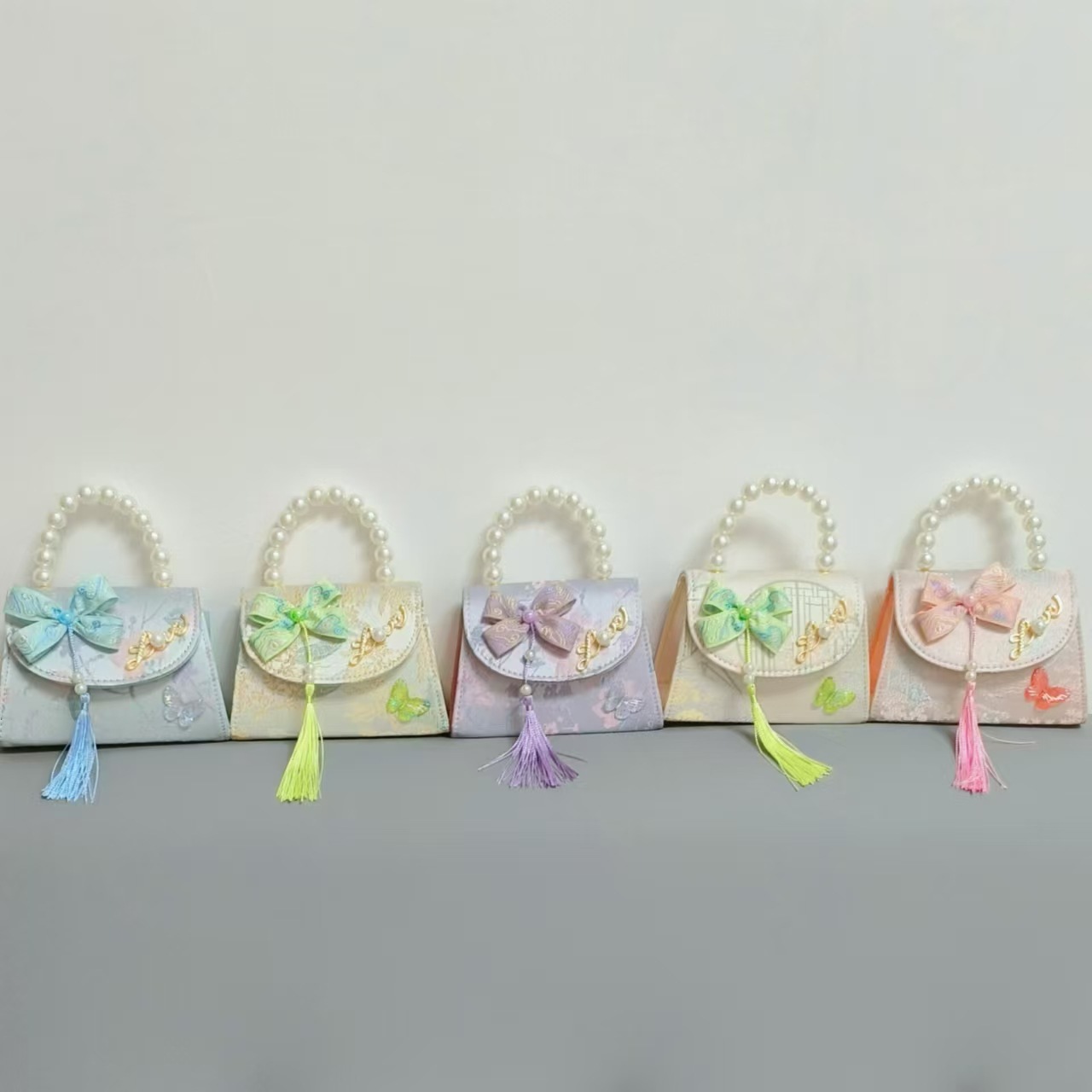 Bolsas de niños arco de estilo chino borda de niña pequeña princesa perla bolsa de cambio de mano al por mayor