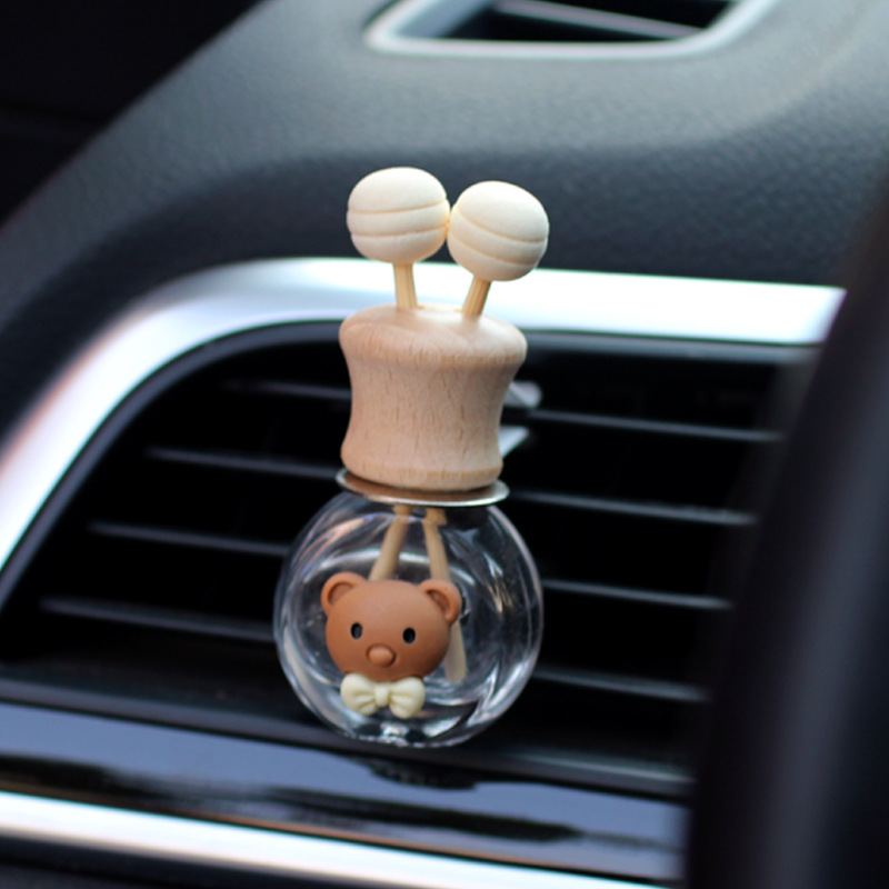 Salida de aire de perfume de coche, dibujos animados, celebridad de Internet, botella de aromaterapia de coche, clip de aire acondicionado, accesorios de coche, bowknot tembloroso