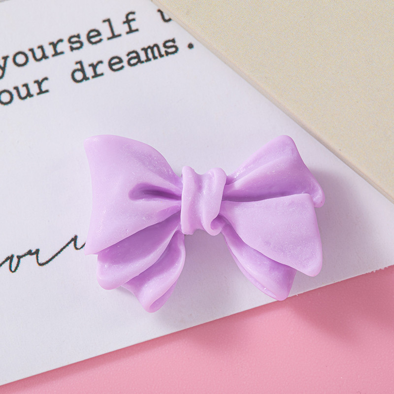 Accesorios de resina de arco de color macaron DIY Crema Accesorios de cuerda de cabello de agujero de caja de teléfono móvil Colgante de hebilla de zapato