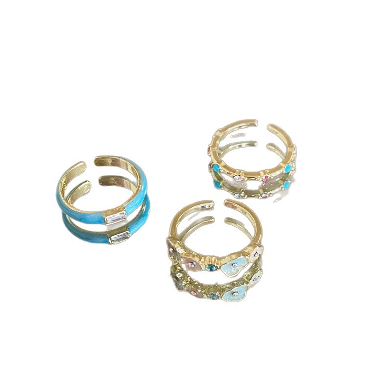 Bague plaquée or véritable, ornée d'une goutte d'huile et d'un zircon en forme de fleur, à niche ouverte pour l'index. Un style raffiné et élégant._voghion.com