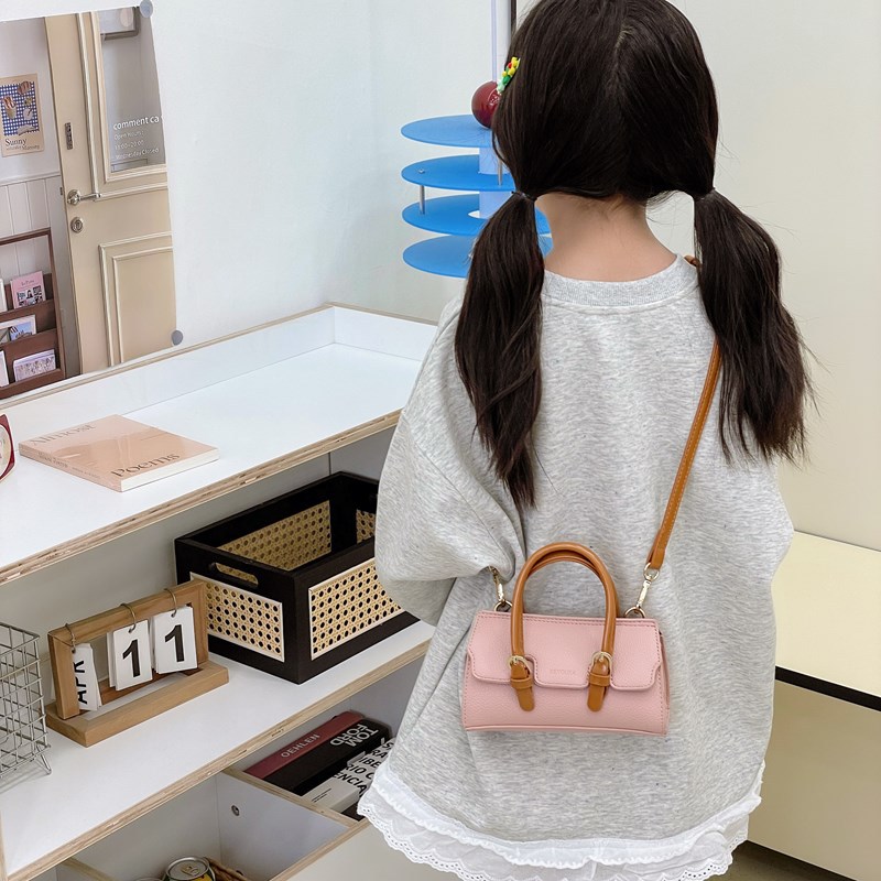 2025 nuevo bolso para niños de comercio exterior, bolso de niña popular de moda coreana, bolso de mensajero para bebé de color sólido de estilo extranjero
