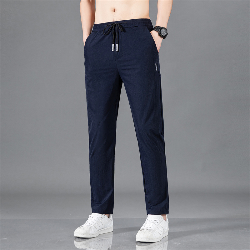 Pantalones largos delgados de verano para hombres tendencia universal de hielo rápido secado deportivo relajado grande pantalones casuales al por mayor