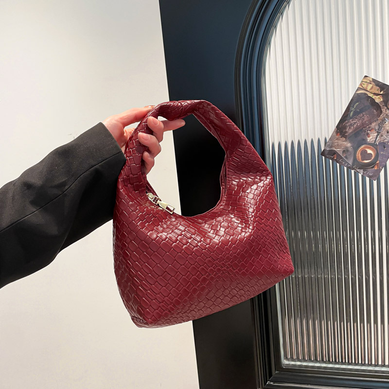 Bolsa de tejido francesa de alto nivel para mujeres 2025 nuevo bolso de bolsillo de nicho de textura de bolso de viaje de bolso de mano universal
