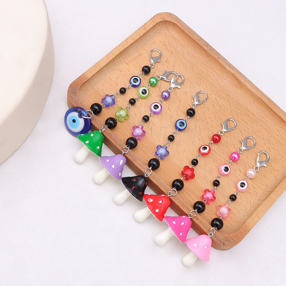 La versión coreana transfronteriza de la joyería de llavero de setas de color, la resina de dibujos animados, el ojo creativo del diablo, el bolso, el colgante de accesorios