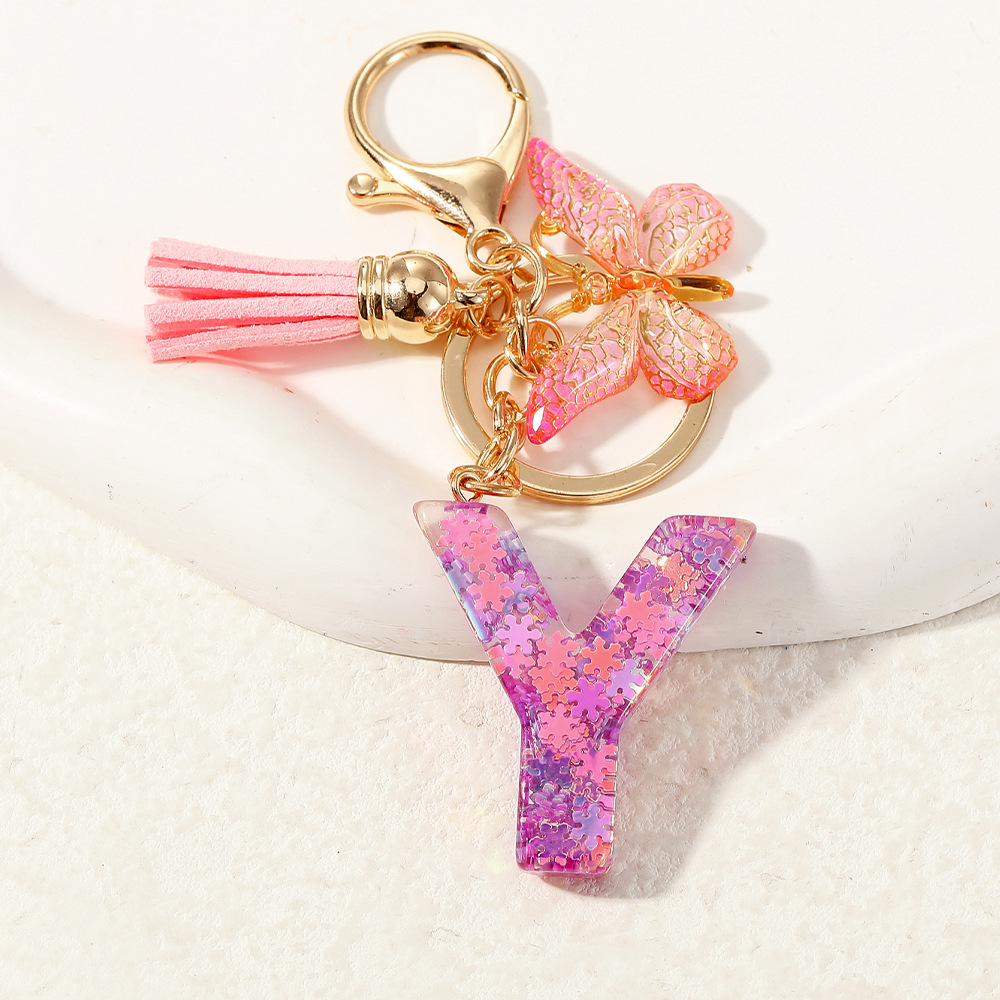 Nuevo color púrpura claro mezcla de polvo brillante letras inglesas resina llave colgante estilo simple mariposa borda colgante