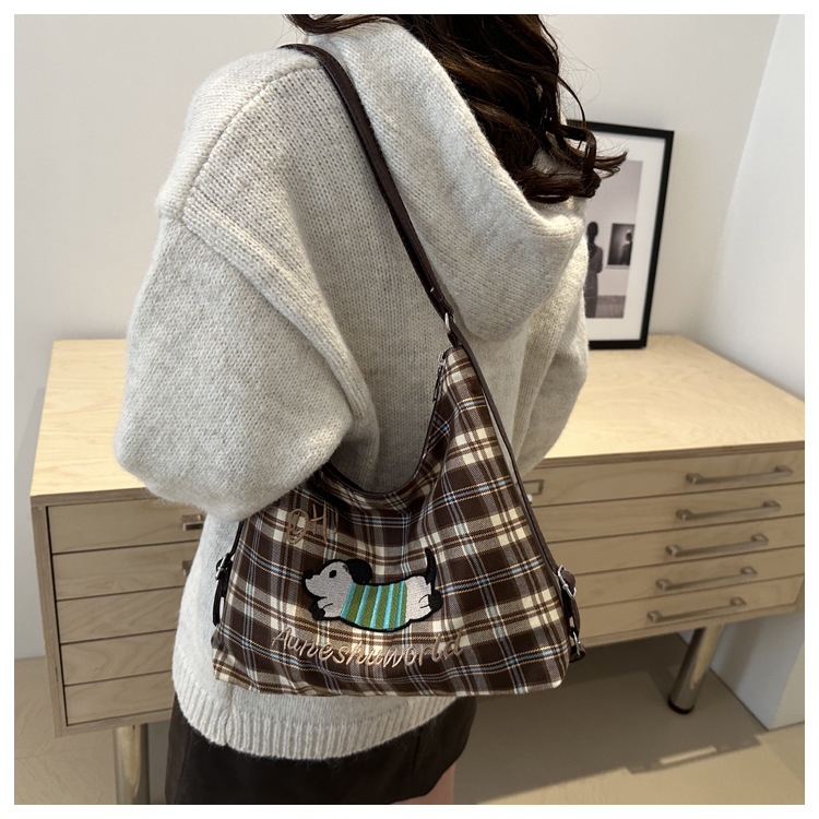 A new 2024 trendy and stylish backpack for women, featuring a cartoon checkered single-shoulder crossbody bag and a tote bag undefined