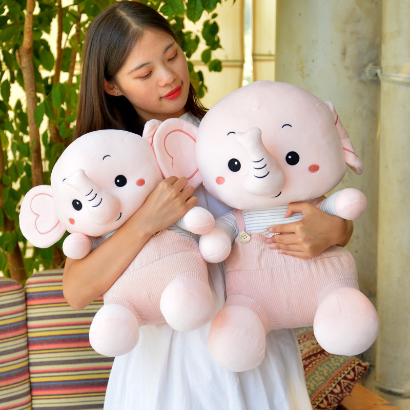 Caricatura muñeca elefante muñeca muñeca de peluche muñeca elefante muñeca niños calmar muñeca almohada en la cama