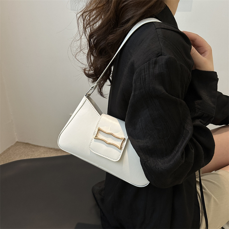 Bolso de brazo ligero de lujo para mujeres 2024 verano nuevo nicho de moda diseño de alta sensación ondulada mochila de hombro