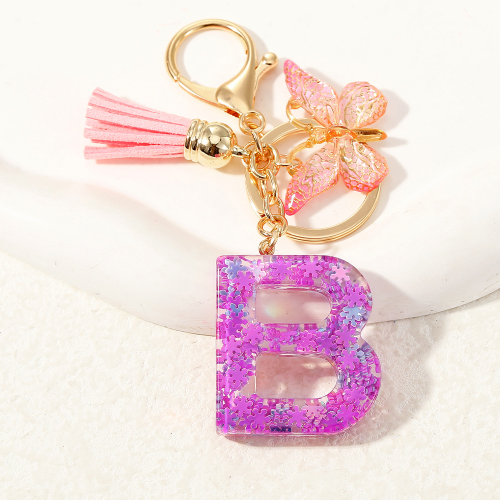 Nuevo color púrpura claro mezcla de polvo brillante letras inglesas resina llave colgante estilo simple mariposa borda colgante