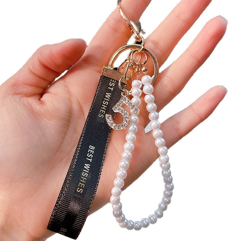 Nuevo simple llavero de arco de perla pequeño bolso colgante de automóvil interior colgante al por mayor
