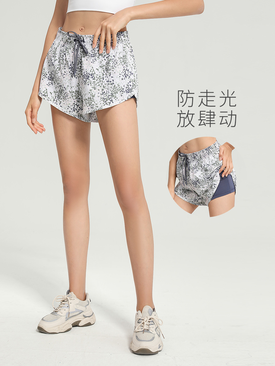 Nuevos pantalones cortos deportivos florales europeos y americanos anti-exposición de las mujeres falsos de dos piezas sueltos de secado rápido transpirable correr fitness yoga Pantalones