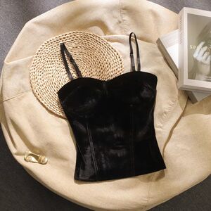 Wearing a short sleeveless top with a padded chest and a bottom on top