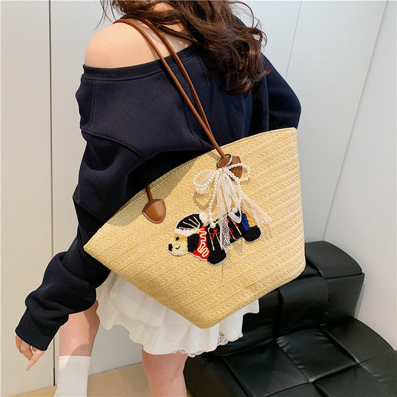 Venta caliente de verano bolso tejido caliente femenino 2025 nuevo bolso de cubo de playa de vacaciones bolso de paja de gran capacidad