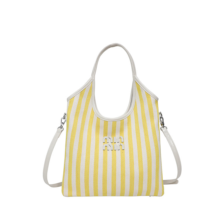 Bolsa de hombro a rayas de lona 2026 nueva sensación de lujo ligera casual diaria gran capacidad mochila