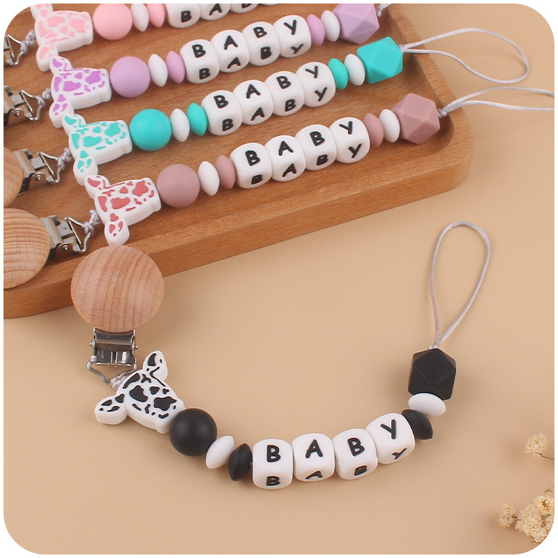 Nuevo bebé suministros de dibujos animados de silicona vaca cabeza mordedor creativo bebé DIY nombre mordedura pezón cadena anti-caída