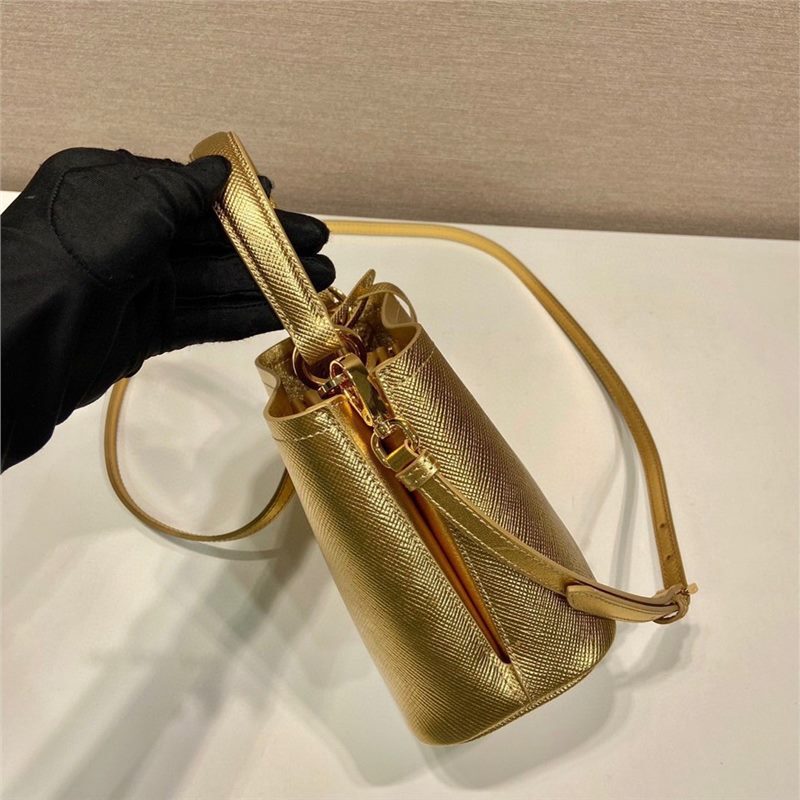 New color bucket bag 1BA373 in gold, crafted from Saffiano leather, features an elegant design for women