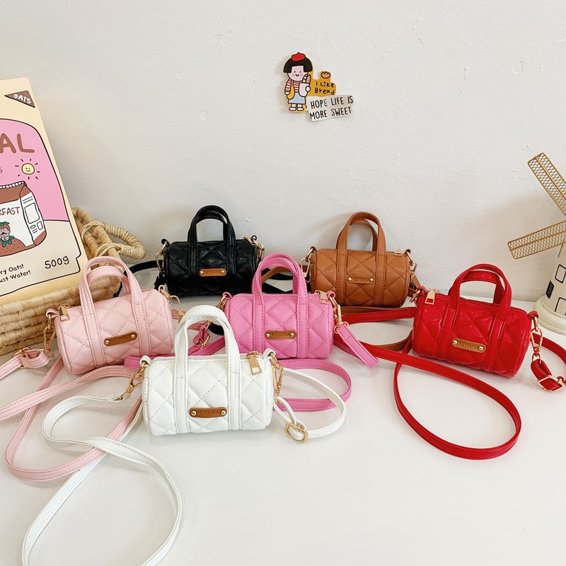 Bolsas infantiles simples de color sólido, bolsas de mini barril de moda coreana, 2025 nuevas bolsas para bebés de comercio exterior