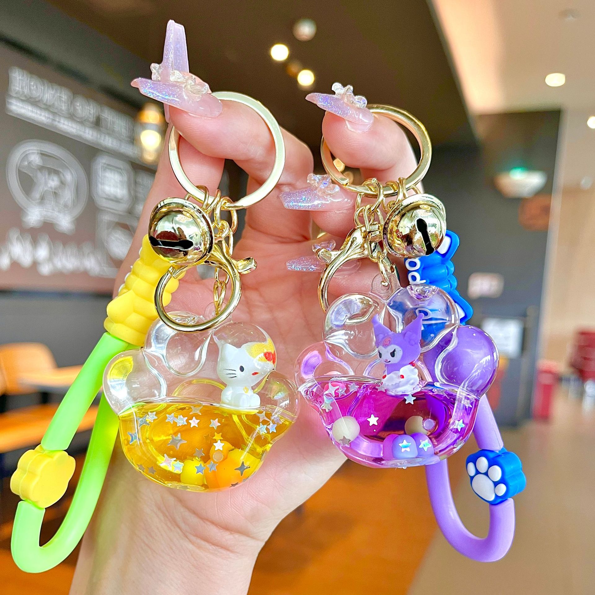 Aceite de gato garra arenas movedizas llavero lindo dibujos animados cadena colgante captura muñeca máquina agarrar pequeño regalo al por mayor