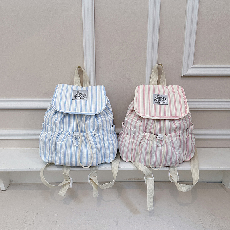 Bolsa de lona a rayas casuales de viento universitario para mujeres verano 2026 nueva mochila simple de gran capacidad mochila de estudiantes