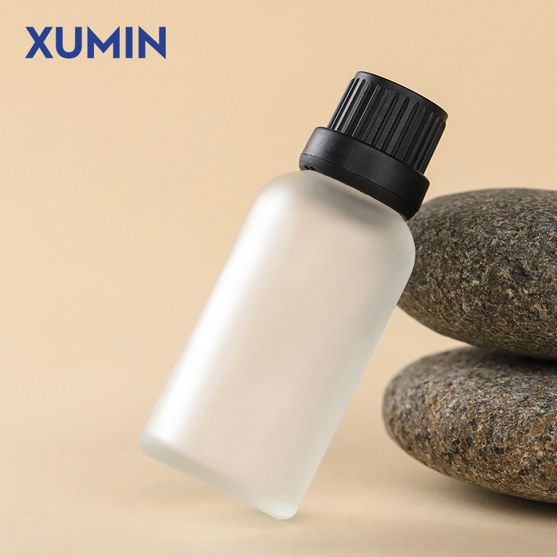 Botella de aceite esencial de vidrio de arena esmerizada al por mayor 30ml botella de muestra pequeña botella de embalaje de cosméticos portátiles