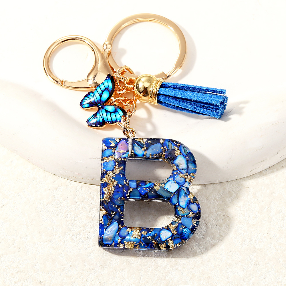 Nuevo transfronterizo mariposa 26 letras inglesas de cristal goteo llavero bolsos accesorios colgante de automóviles