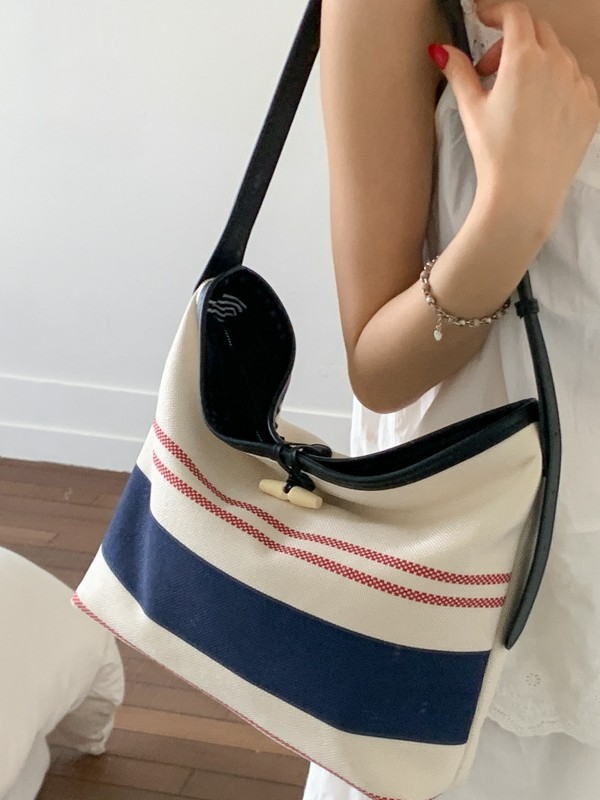 Bolso mujer 2025 nuevo bolso de cubo a rayas simple moda bolso de hombro casual de alta gama bolso de mensajero casual