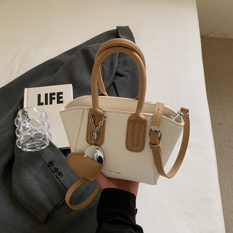 Bolso de cubo portátil de estilo caliente de moda para mujer 2025 nuevo bolso de hombro retro de nicho bolso de mensajero de moda de todo fósforo de moda