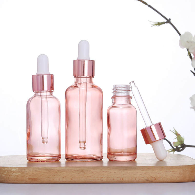 Botella de aceite esencial de color rosa transparente Esencia de líquido sub-botella gotero de vidrio Aceite de Masaje puro Rocío líquido sub-envasado de vidrio botella vacía