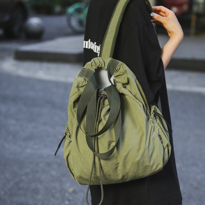 Mochila de nailon con cordón para mujer 2024 nuevo bolso de cubo de doble uso de un solo hombro literario simple para estudiantes universitarios