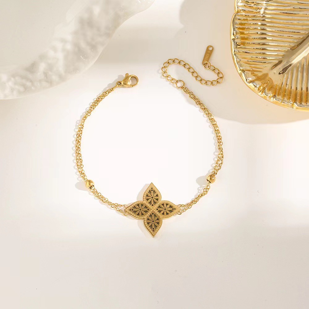 Pulsera de trébol de acero titanium vendedora caliente transfronteriza europea y americana con incrustaciones de concha pulsera colgante pulsera de diseño avanzado sin desvanecimiento al por mayor