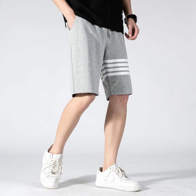 Nuevos pantalones cortos de estilo americano de verano de moda masculino delgado diseño de nicho relajado pantalones deportivos casuales de cinco puntos