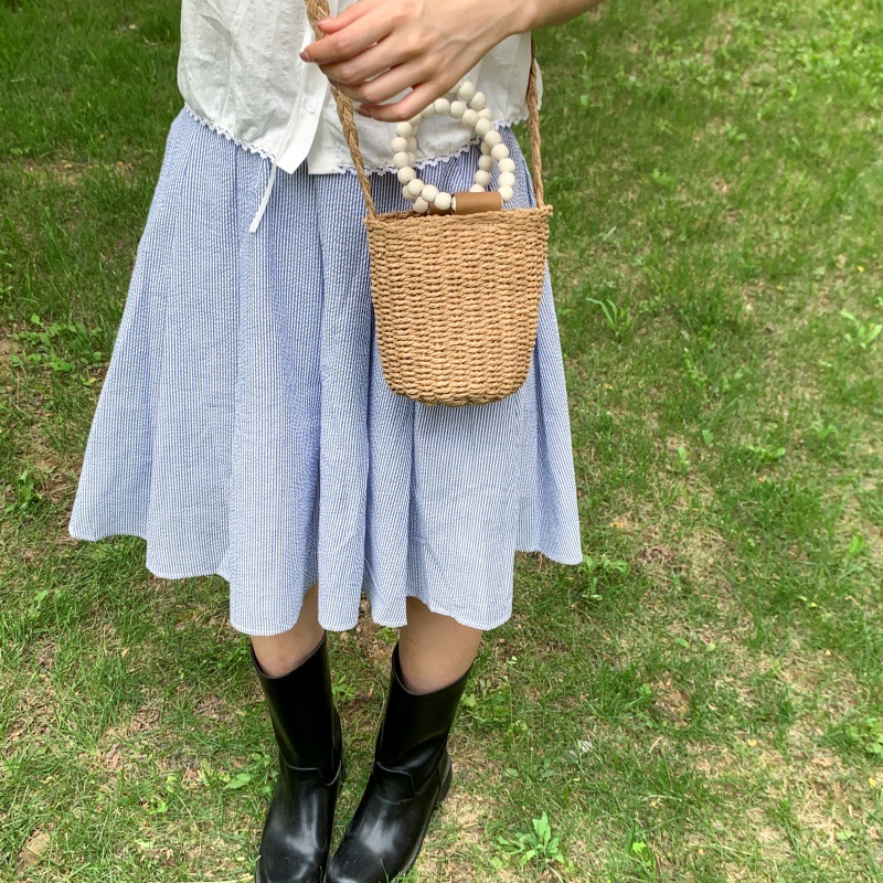 Bolso de cubo de vacaciones junto al mar 2025 nuevo bolso de mujer bolso de hombro de playa tejido de paja mini bolso de mensajero con cuentas