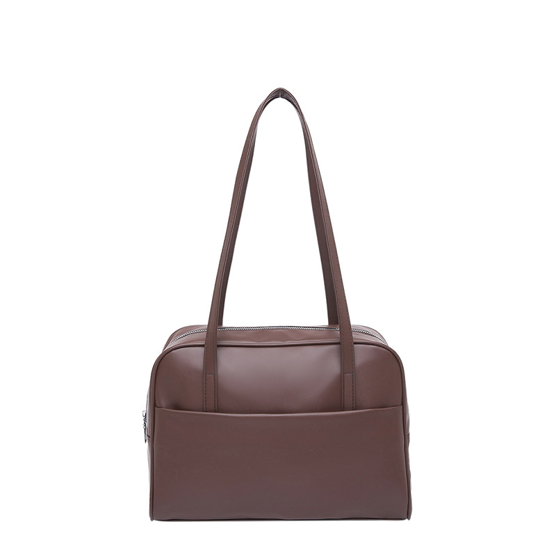 Bolso de hombro coreano de gran capacidad para mujeres 2025 primavera nuevo bolso de brazo retro estilo extranjero bolso de viento minimalista