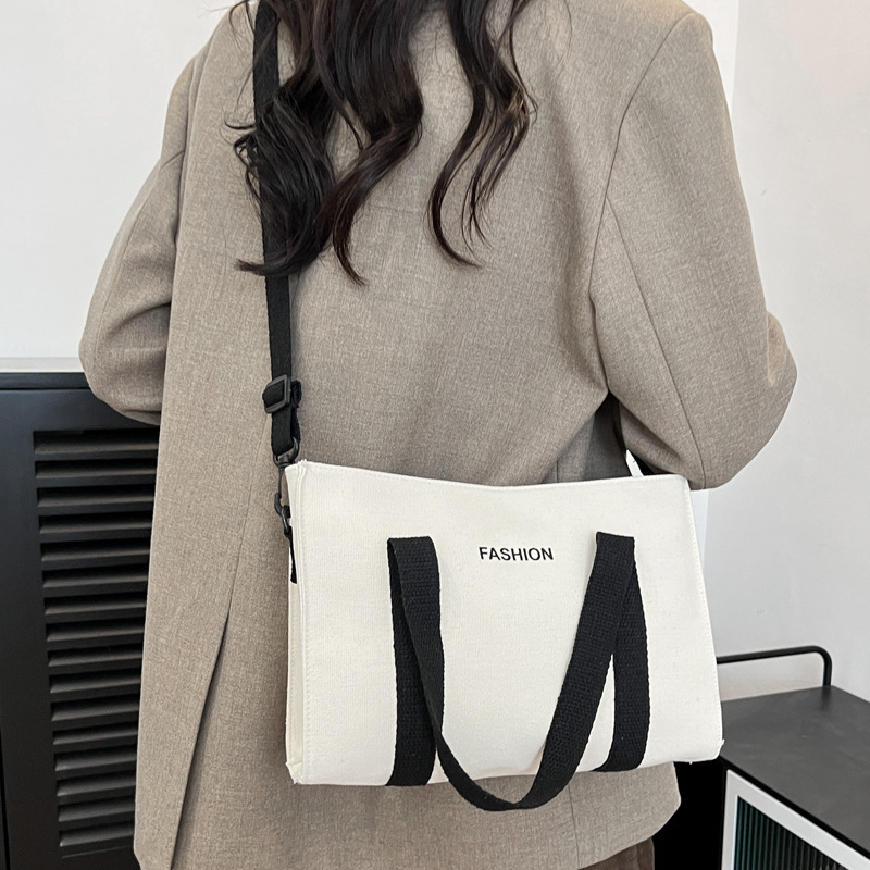 2024 nuevo simple japonés blanco y negro bolso de tela de gran capacidad para estudiantes de clase de viaje mochila de hombro