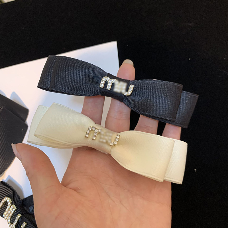 Elegant black hairgrip with letters