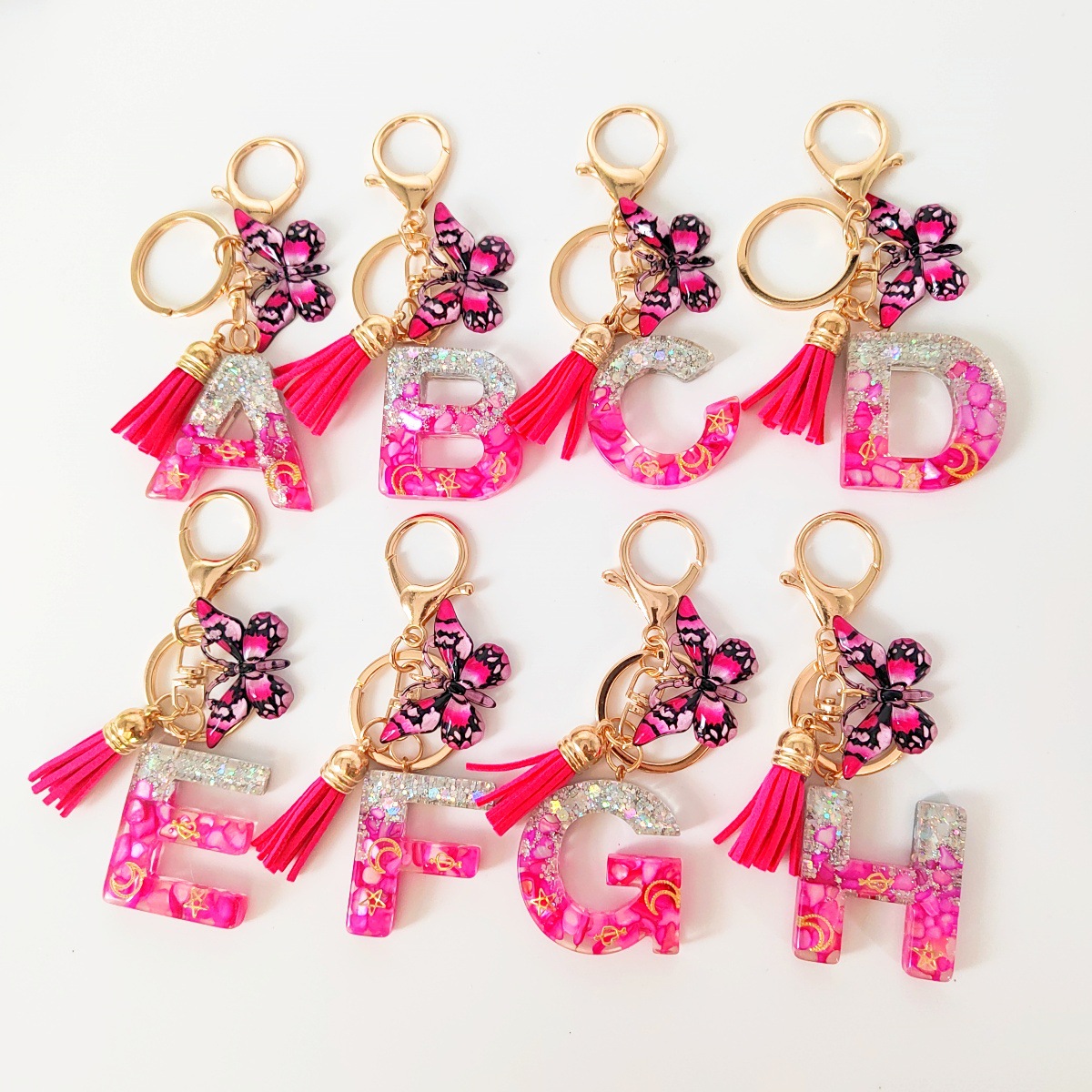 Inventario transfronterizo nueva resina bicolor mariposa borda llavero colgante estrella luna accesorios de joyas