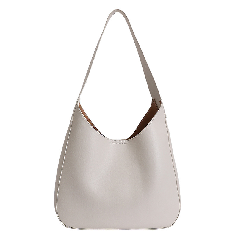 Nicho de diseño simple bolso de cubo portátil para mujeres 2026 primavera nueva moda perezosa retro bolso de brazo diario