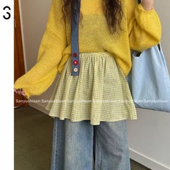 韓系は甘くて小さいおならのカーテンの黄色の半身のスカートの裾を重ねてお尻を遮って小さいスカートの格子のスカートの女性を飾ります。