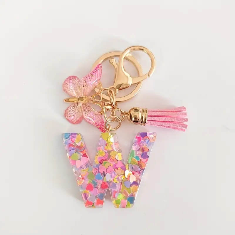 2024 transfronteriza en stock resina rosa con lentejuelas 26 letras inglesas llavero colgante mariposa borla Accesorios