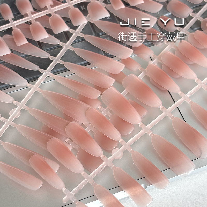 New pre-coated press-on nails in nude gradient blush colors, available in various sizes, suitable for use in nail salons as semi-finished nail products