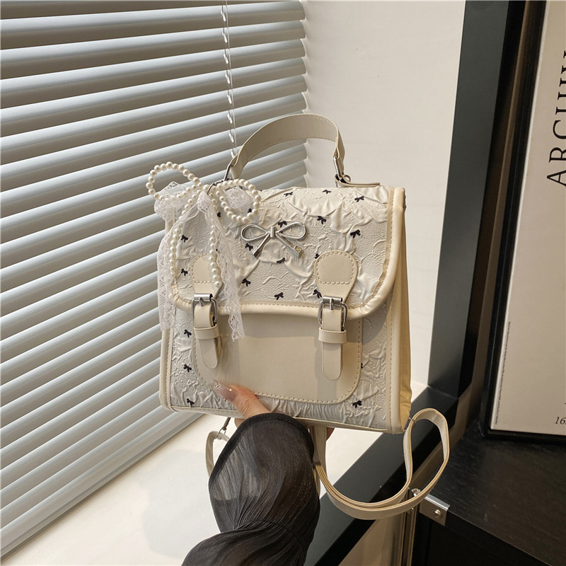 Escuela de viento impresión de arco mochila pequeña mujer verano 2025 nueva moda coreana estilo exterior mochila de viaje ocio