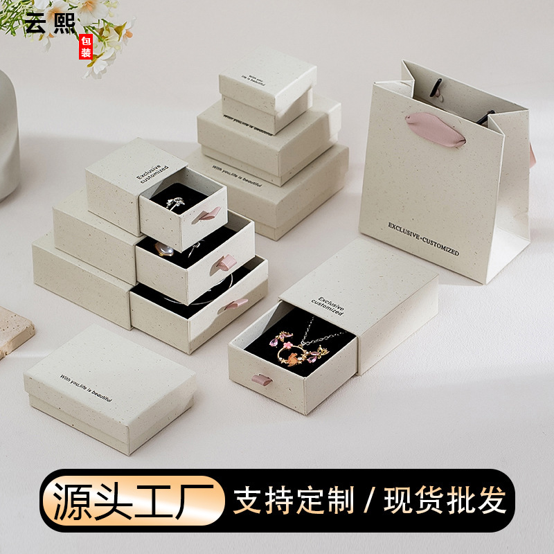 Manufacturer's in-stock recycled paper jewelry boxes with clear texture for rings, necklaces, and bracelets