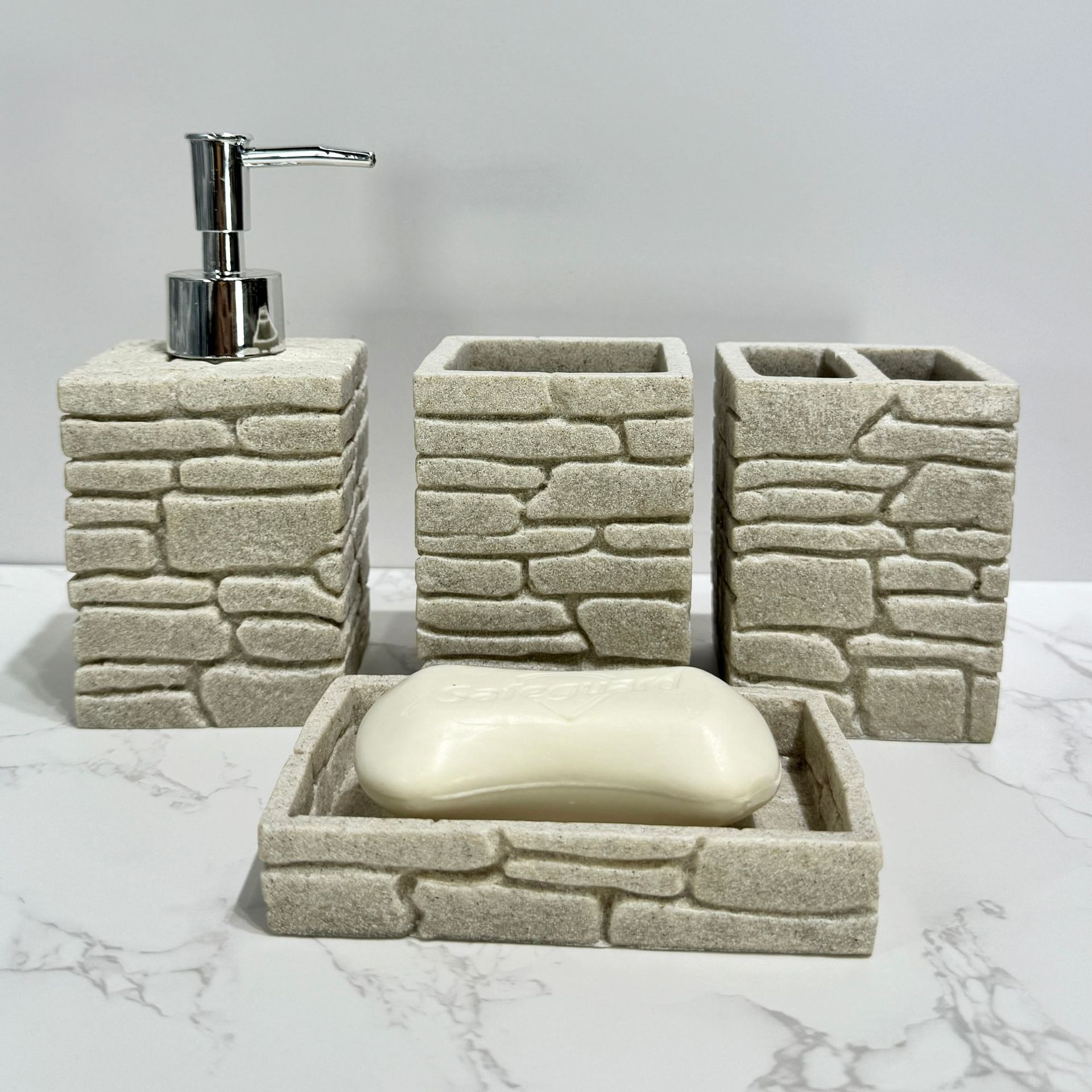 Imitación de diseño de arena y grava, baño de cuatro piezas, juego de decoración de baño de hotel de estilo europeo, botella de desinfectante de manos transfronterizo