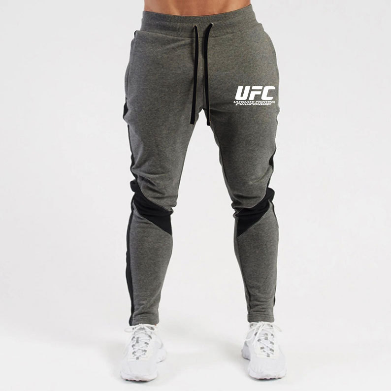 Otoño e invierno letras deportivas juventud ordinaria media elástica Mediados de cintura pantalones de algodón negro en stock moda de lana pantalones de los hombres